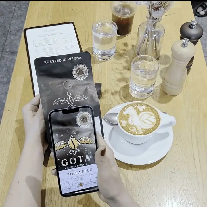 A bag of Gota Coffee scanned with a phone, the packaging animating