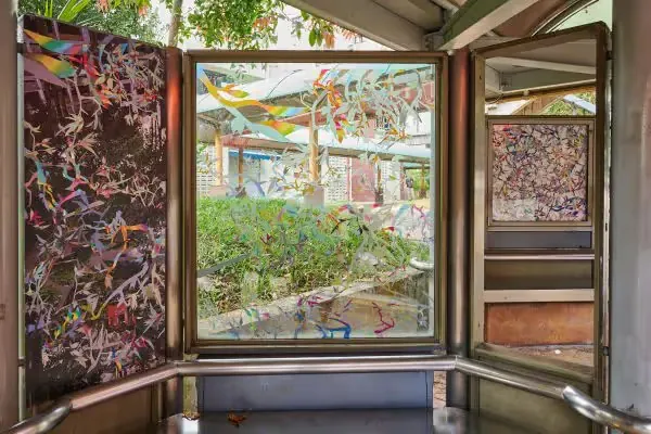 Singapore bus stop with Andy Yang's colorful artwork on glass and panels as part of Bus.Stop.Art