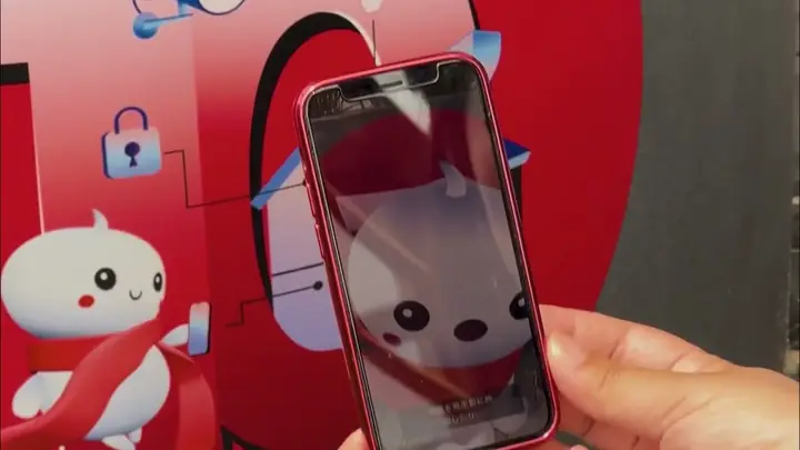 A visitor scans a sticker at the Austria Pavilion, Expo 2025 Osaka, and the AR survey opens on the phone