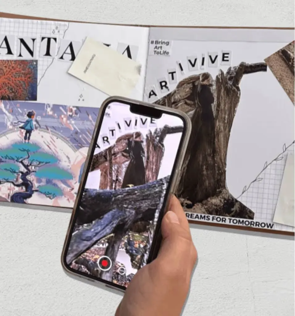 A phone held over a scrapbook page collaged from FANTASIA prints, a tree with a hidden figure coming to life on screen